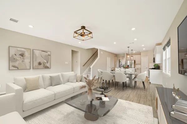 a living room with lots of furniture and painting on the wall