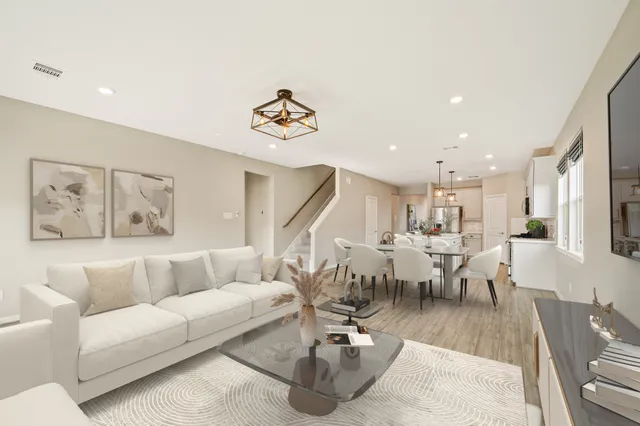 a living room with lots of furniture and painting on the wall