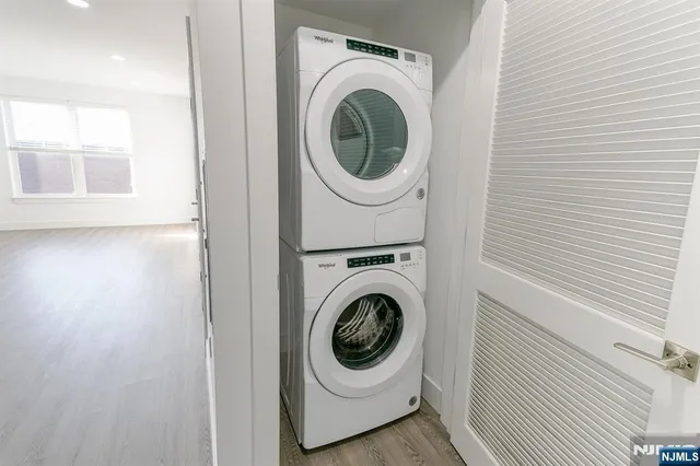 a utility room with sink dryer and washer