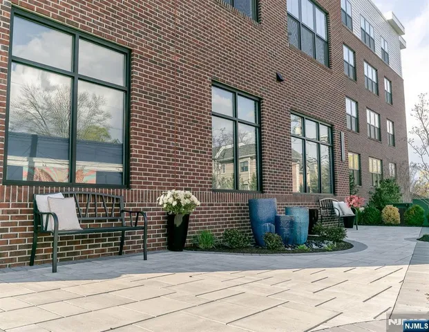 a front view of a brick house with a large windows