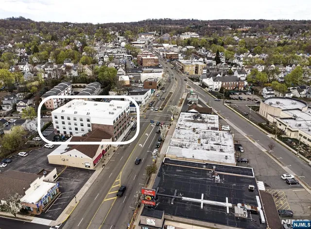 an aerial view of a residential apartment building with a city view