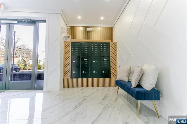 a view of hallway with furniture and wooden floor