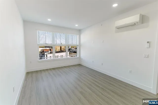 a view of a room with wooden floor and window