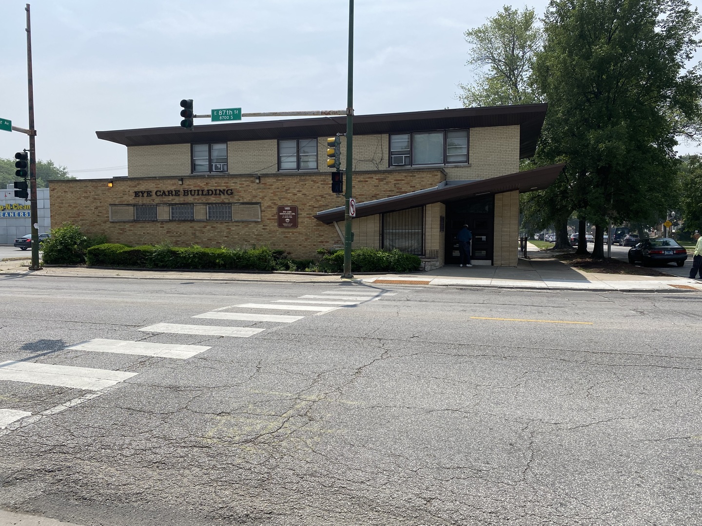 a front view of a house with a street