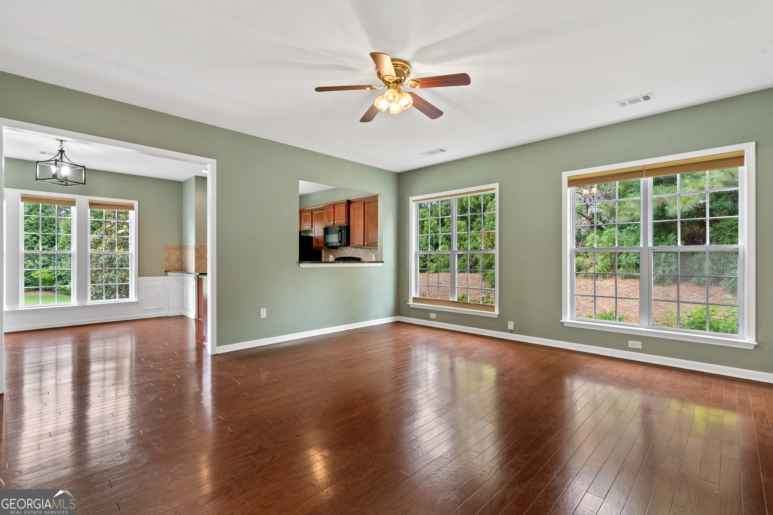 1370 Summer Hollow Road Greensboro, GA 30642 - Photo 11 of 35 a view of an empty room with wooden floor and a window