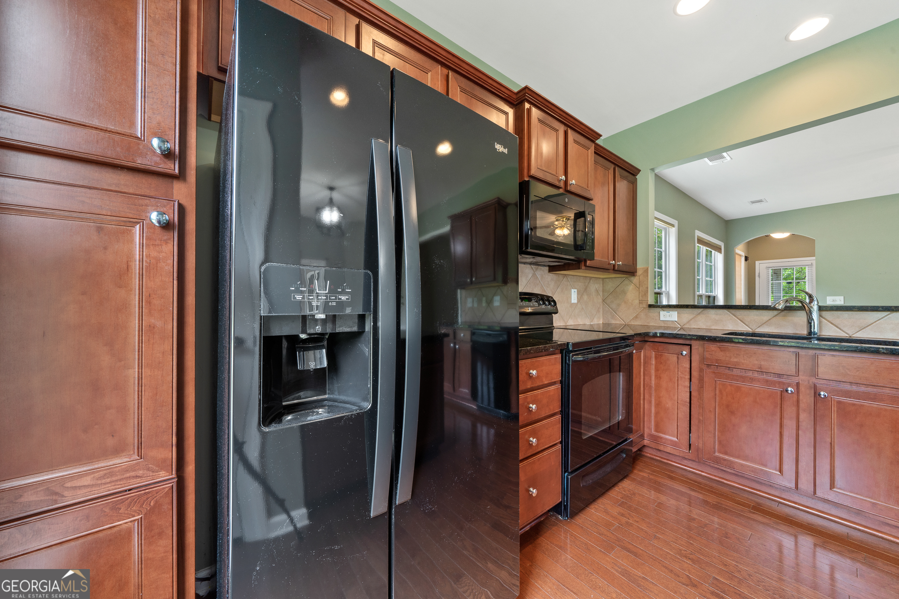 1370 Summer Hollow Road Greensboro, GA 30642 - Photo 17 of 35 a kitchen with stainless steel appliances granite countertop a refrigerator and a sink