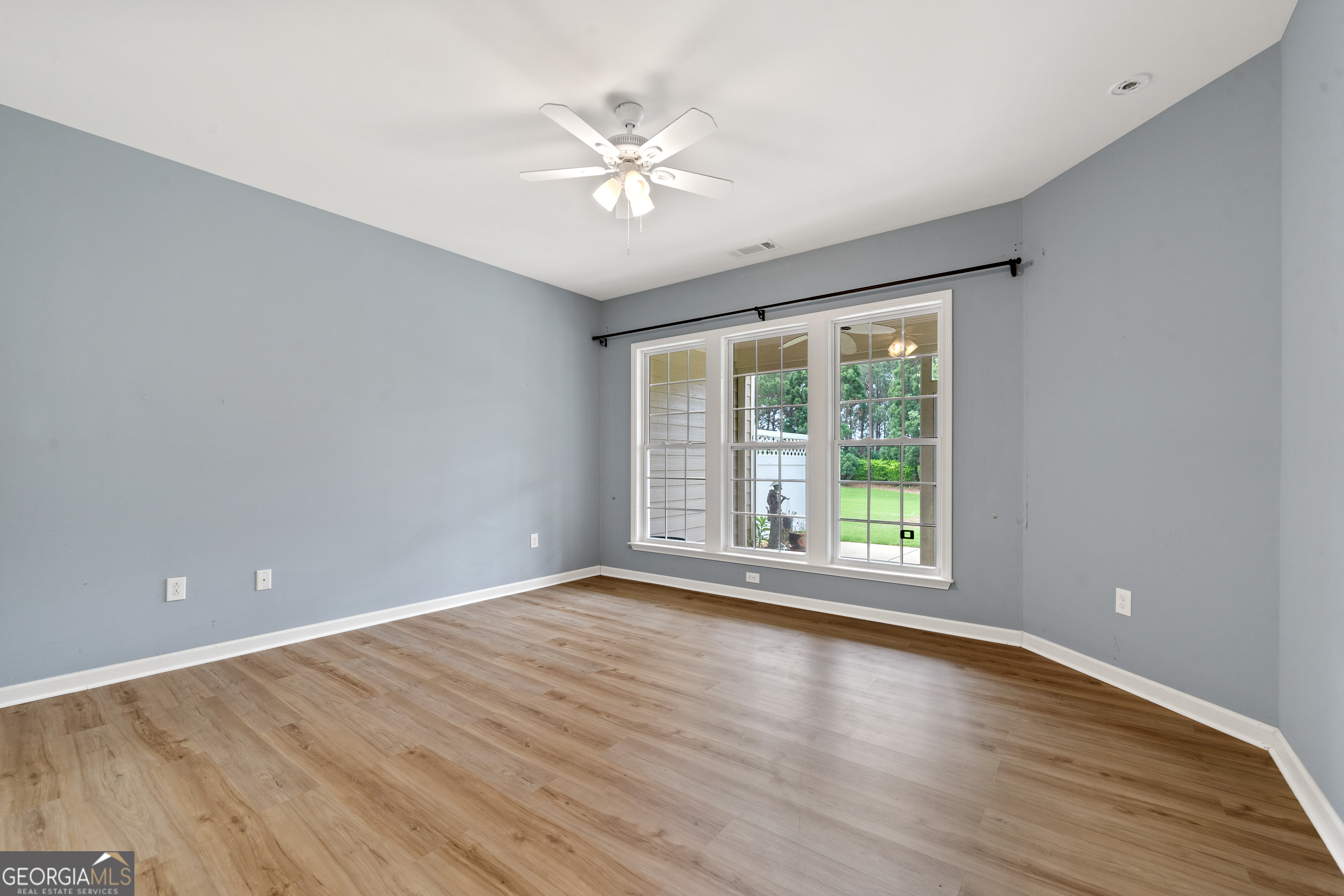 1370 Summer Hollow Road Greensboro, GA 30642 - Photo 20 of 35 a view of an empty room with wooden floor and a window