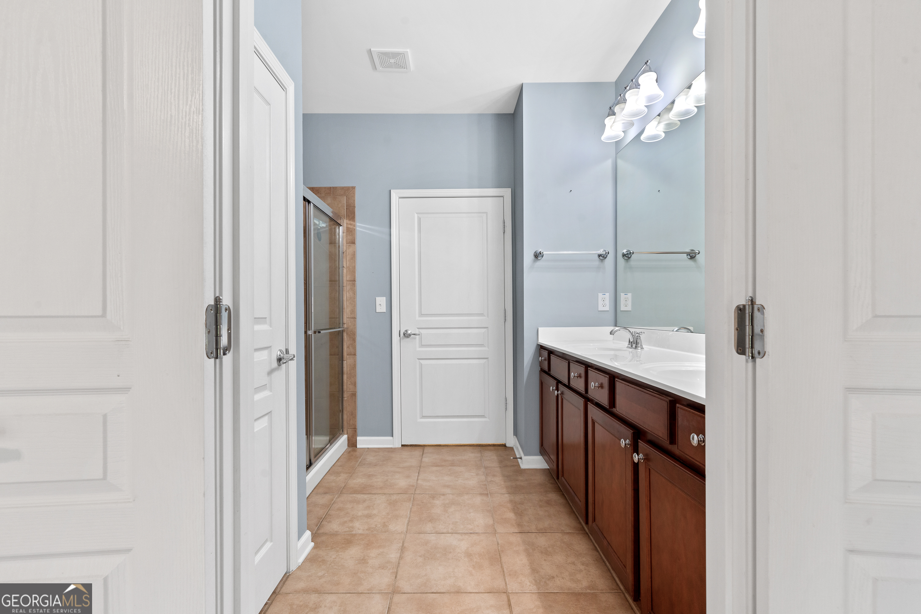 1370 Summer Hollow Road Greensboro, GA 30642 - Photo 22 of 35 a spacious bathroom with a double vanity sink a mirror and a shower