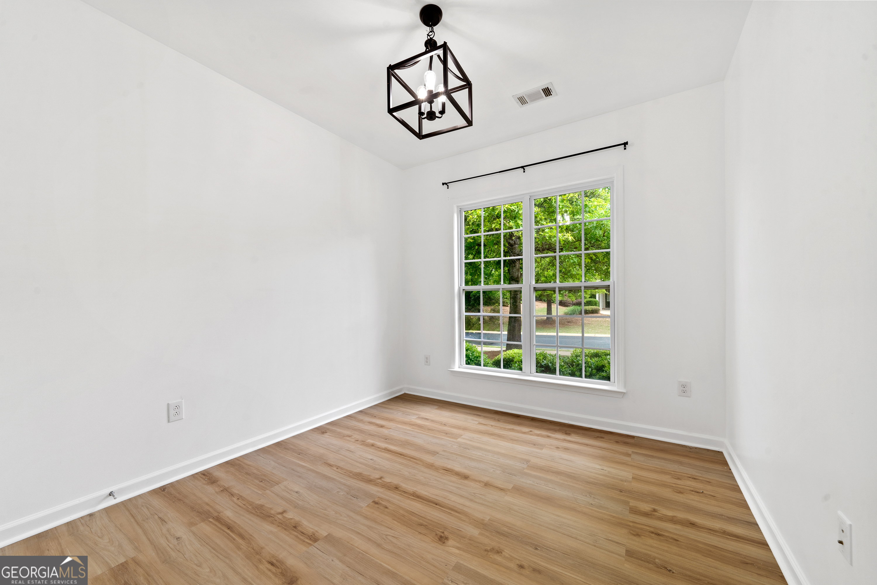 1370 Summer Hollow Road Greensboro, GA 30642 - Photo 29 of 35 a view of an empty room with wooden floor and a window