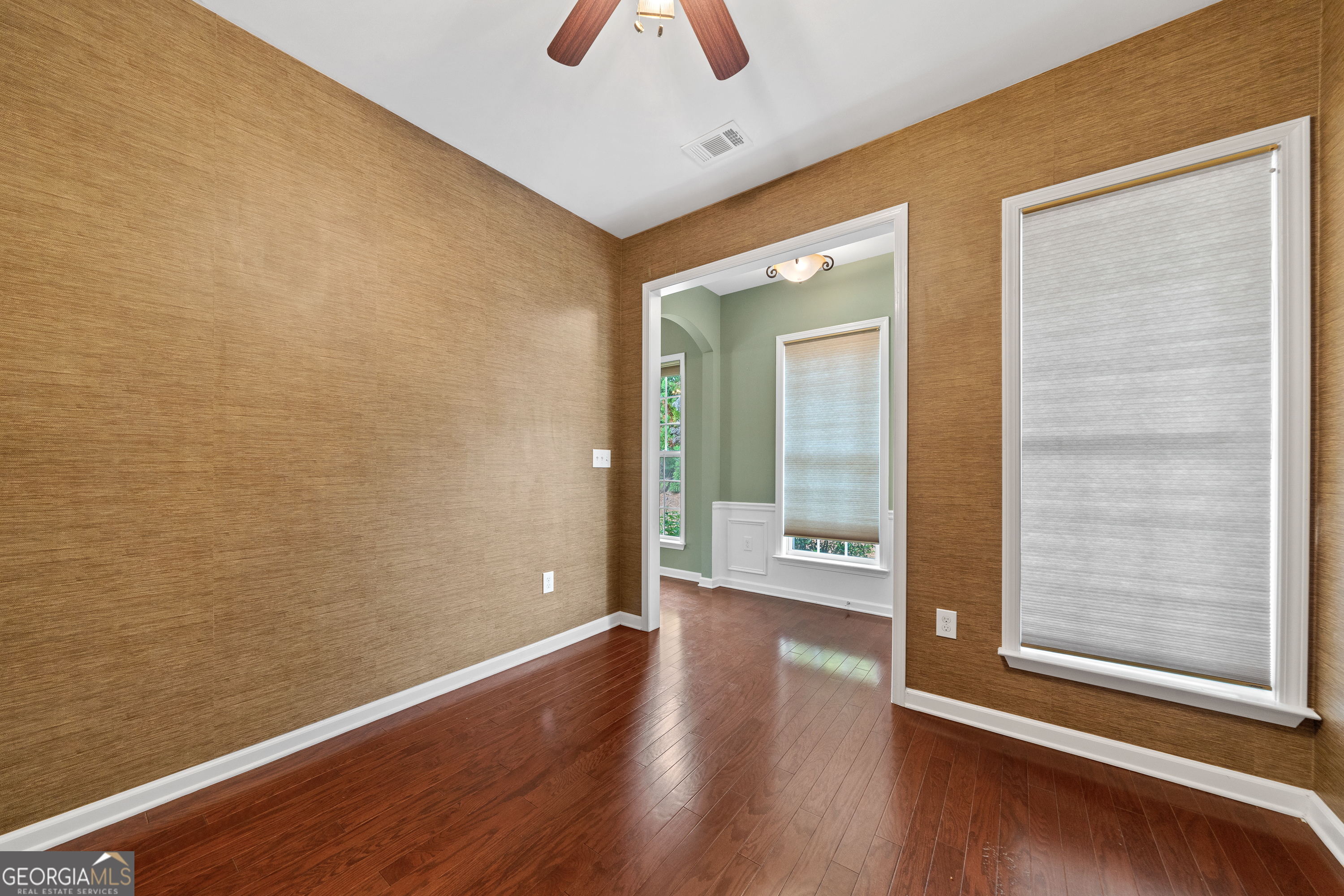 1370 Summer Hollow Road Greensboro, GA 30642 - Photo 6 of 35 a view of a hallway with wooden floor and a large mirror