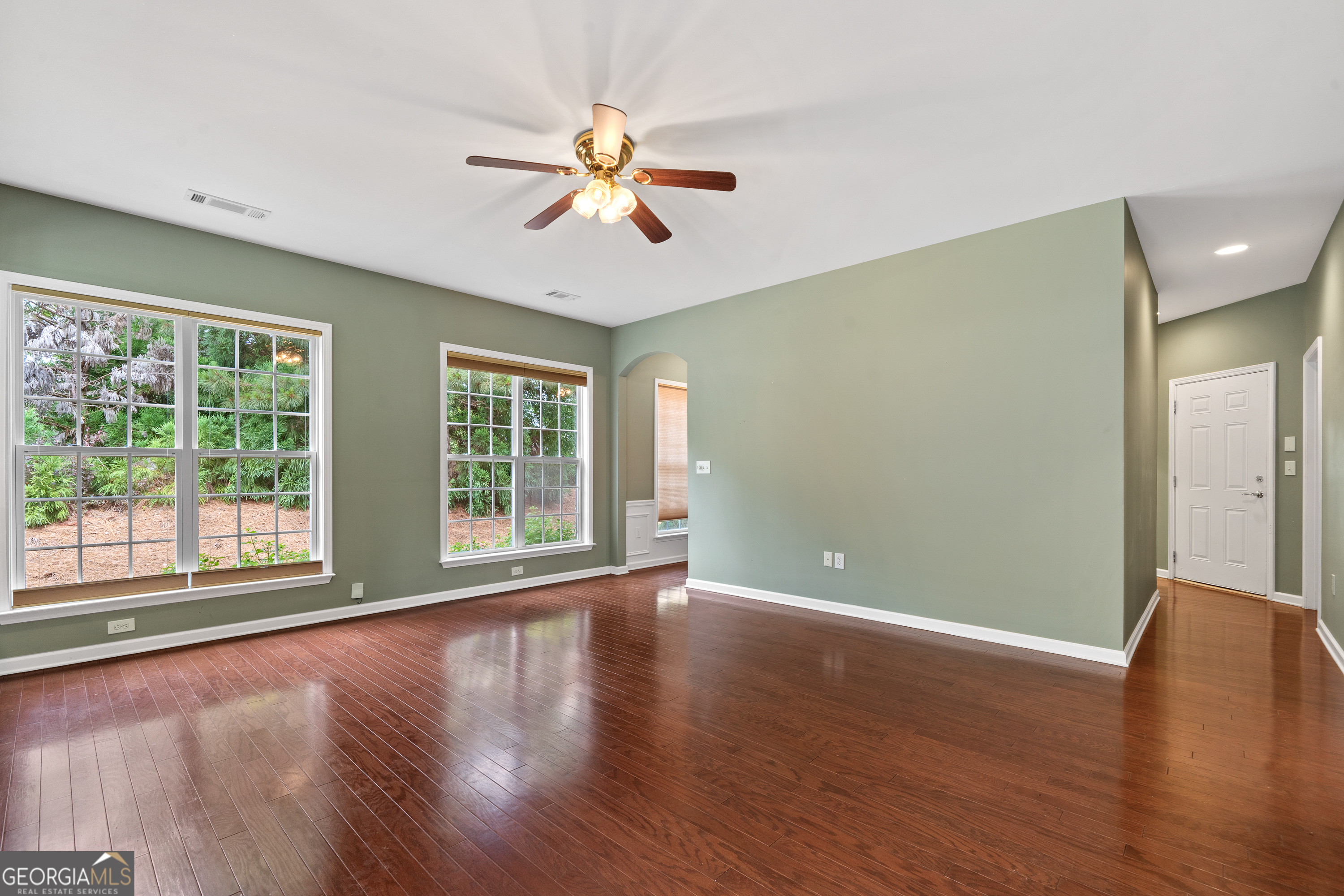 1370 Summer Hollow Road Greensboro, GA 30642 - Photo 9 of 35 a view of an empty room with wooden floor and a window