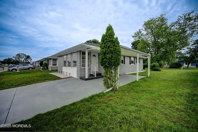 a front view of house with yard and green space