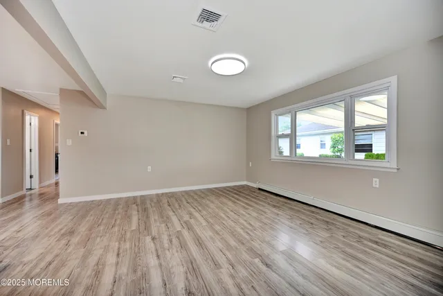 a view of kitchen with wooden floor and window