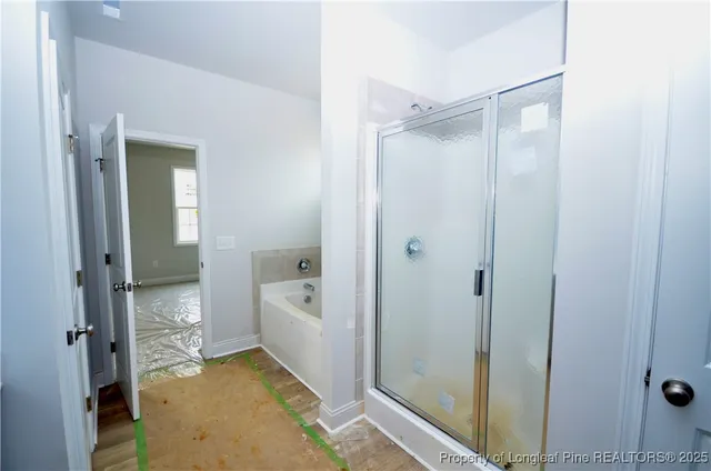 a bathroom with a tub shower and a sink
