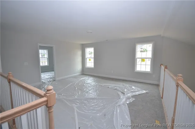 a view of a livingroom with wooden floor and window
