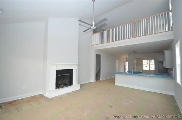 a view of a livingroom with an empty space and a fireplace