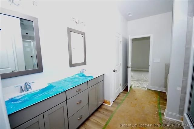 a spacious bathroom with a double vanity sink and a mirror