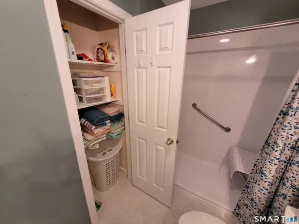 a bathroom with a shower curtain and a toilet