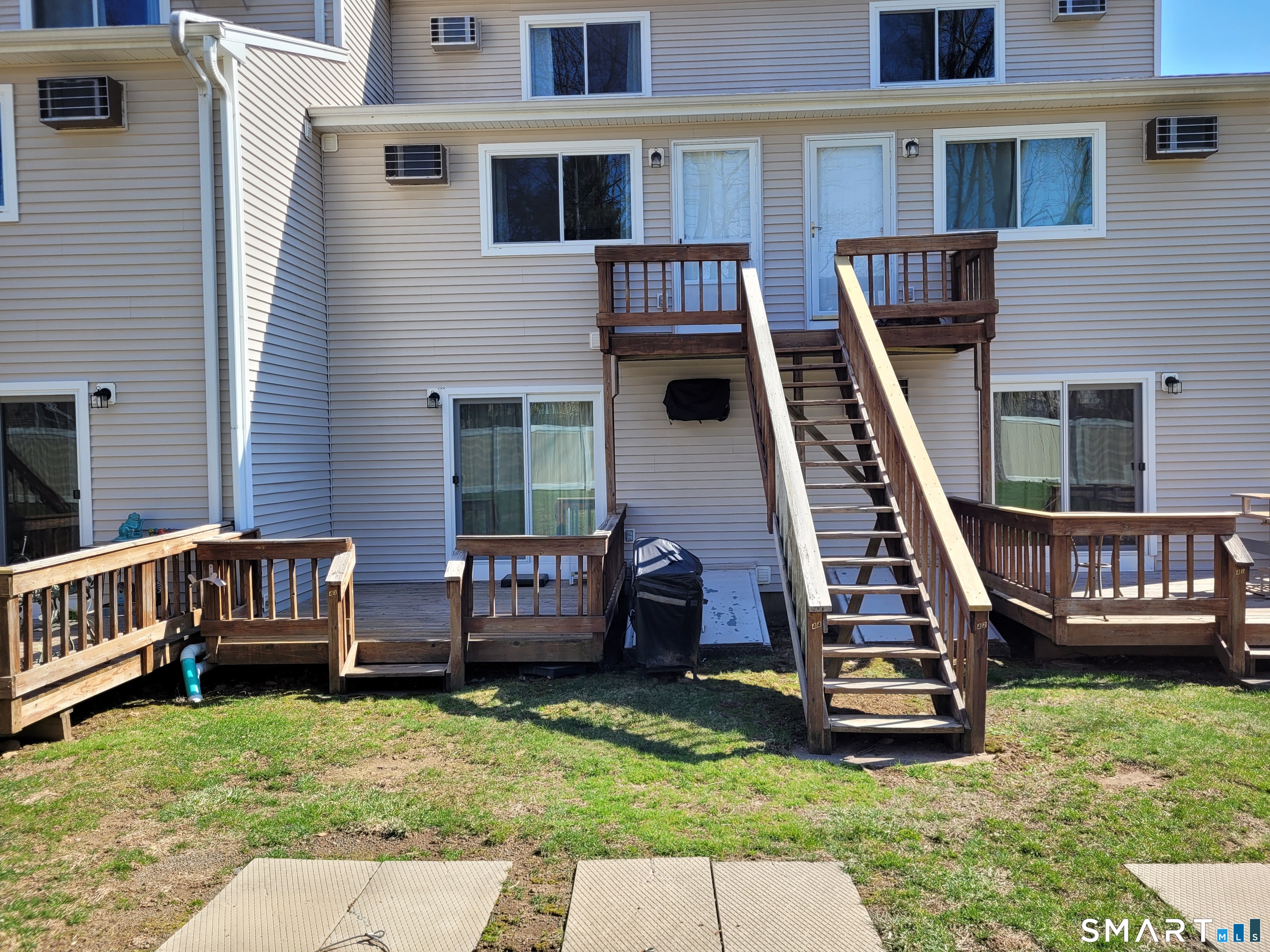 35 Ruth Street, Unit 44 Bristol, CT 06010 - Photo 33 of 35 a backyard of a house with barbeque oven and a couch