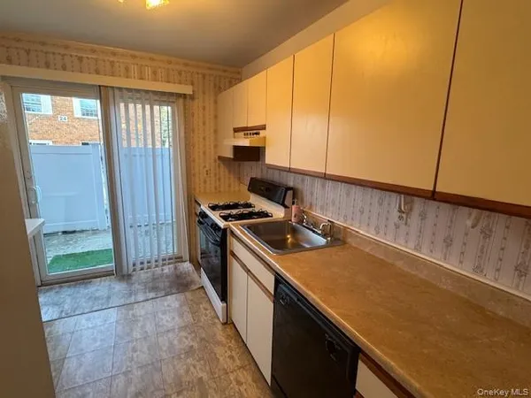 a kitchen with a sink a stove and a refrigerator