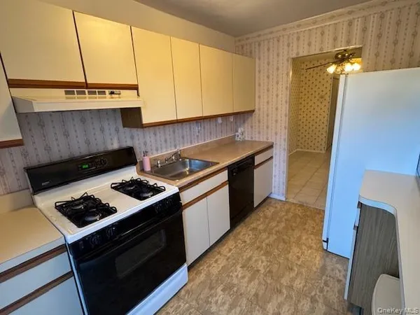 a kitchen with a stove and a refrigerator