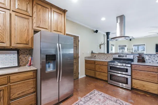 a kitchen with granite countertop stainless steel appliances and wooden cabinets