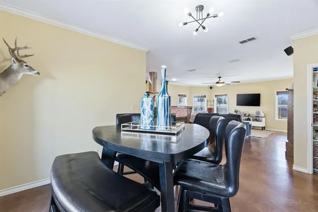 a dining room with furniture and wooden floor