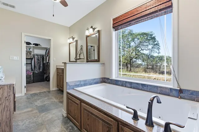 a bathroom with a tub and a view of bathroom