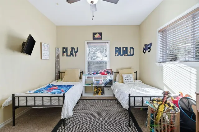 a bedroom with two beds and a table