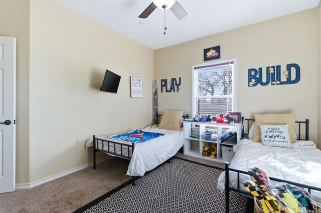 a bedroom with a bed and a tv