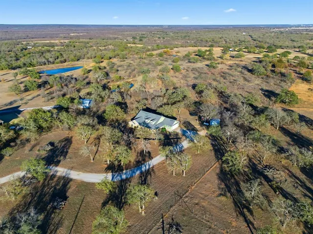 an aerial view of residential building and lake