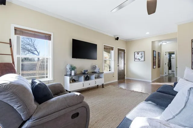 a living room with furniture and a flat screen tv