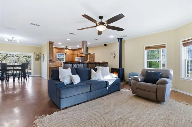 a living room with furniture and kitchen view