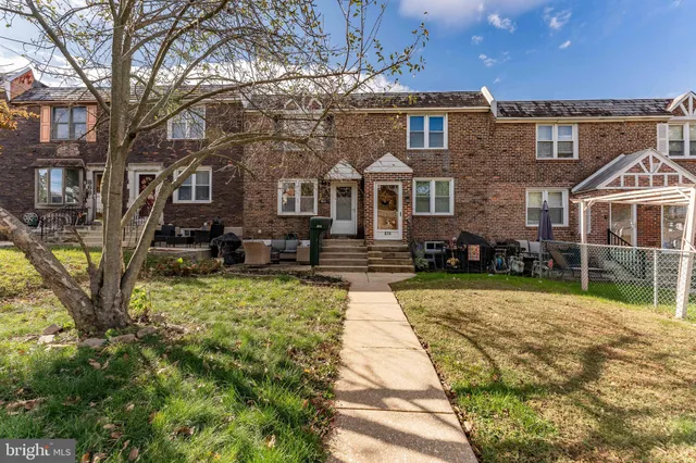a house with tall trees in the background