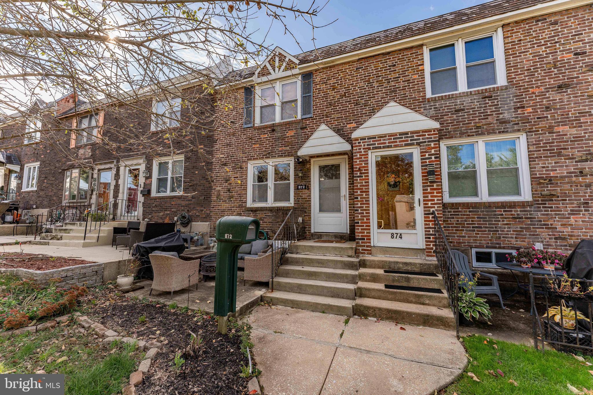 872 Fairfax Road Drexel Hill, PA 19026 - Photo 2 of 31 a view of a brick house with many windows and a table and chairs