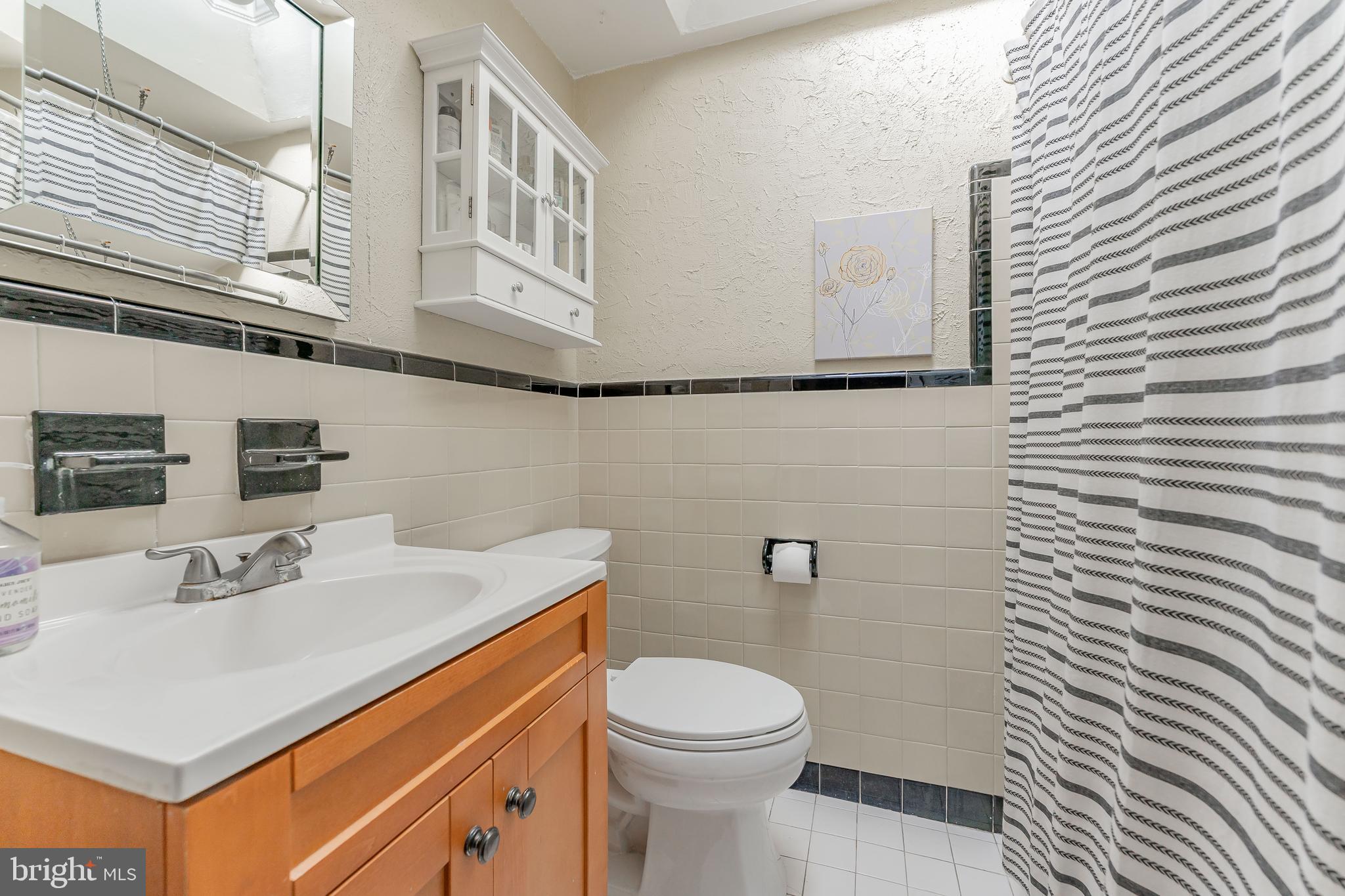 872 Fairfax Road Drexel Hill, PA 19026 - Photo 27 of 31 a bathroom with a sink a toilet and mirror