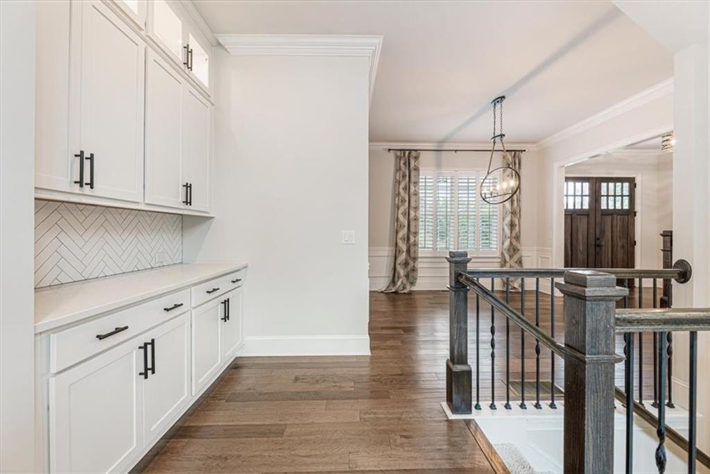 947 Hunter Way Milton, GA 30004 - Photo 22 of 78 a view of a hallway with wooden floor and staircase