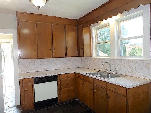 a kitchen with a sink cabinets and window