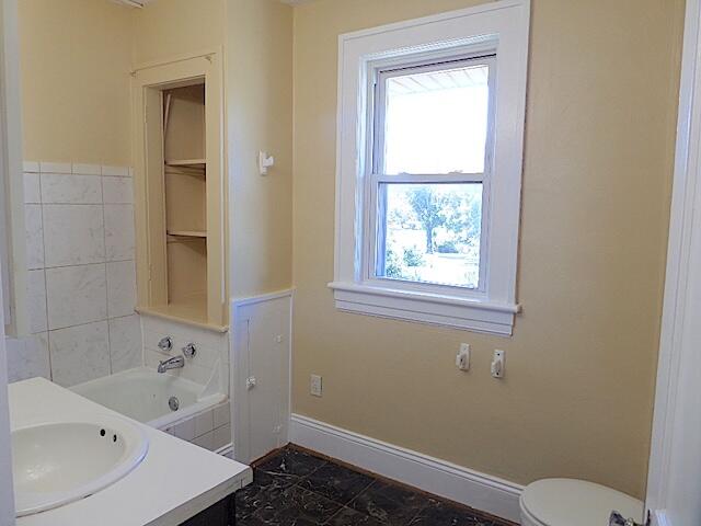 417 Fieldale Road Northeast Roanoke, VA 24012 - Photo 30 of 37 a bathroom with a bathtub and window