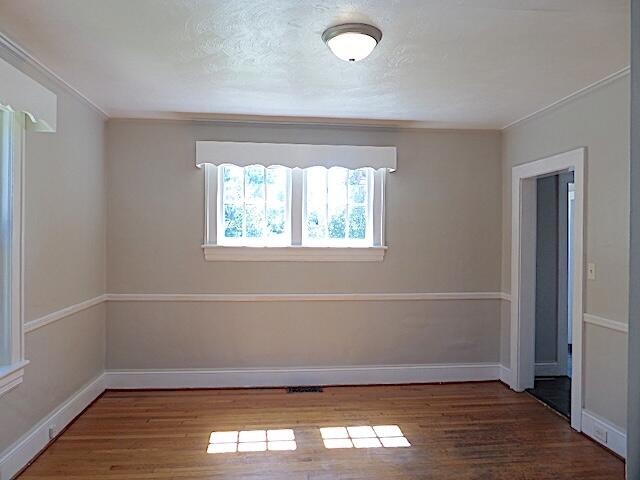 417 Fieldale Road Northeast Roanoke, VA 24012 - Photo 8 of 34 an empty room with wooden floor and windows