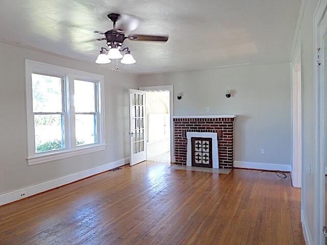 417 Fieldale Road Northeast Roanoke, VA 24012 - Photo 8 of 37 an empty room with wooden floor a chandelier fan and windows