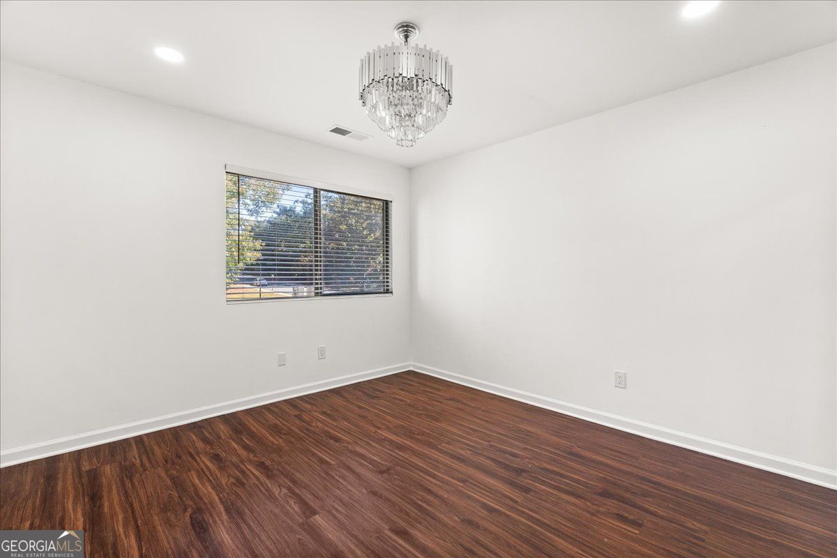 3755 Mulkey Road Marietta, GA 30008 - Photo 11 of 17 an empty room with wooden floor and windows
