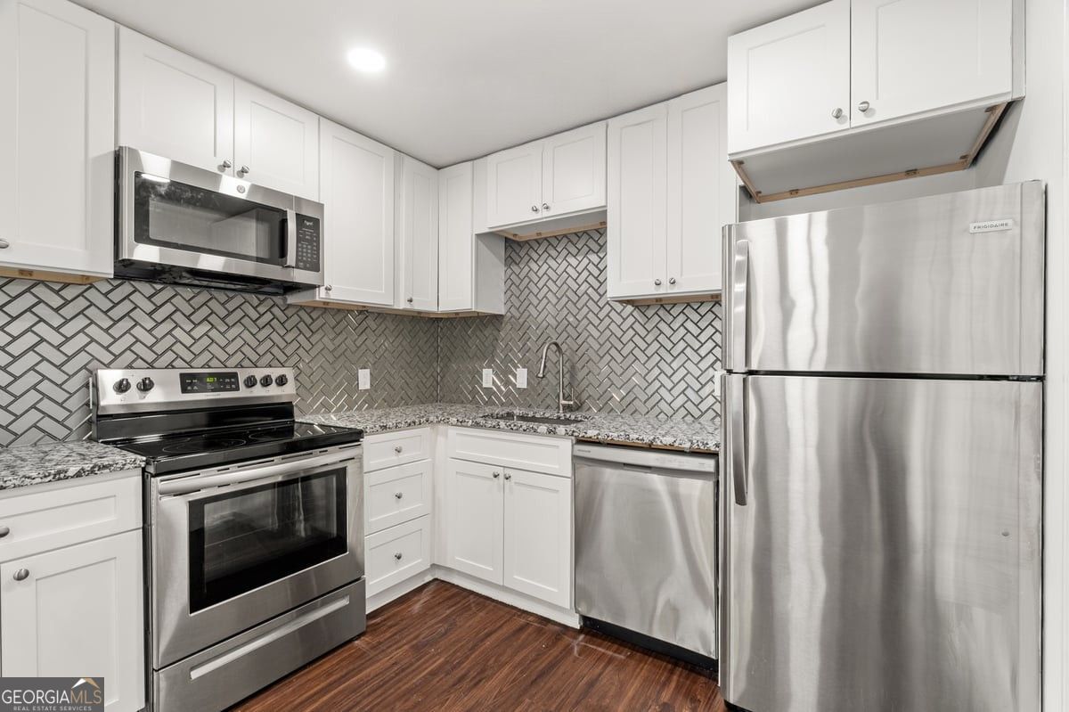 3755 Mulkey Road Marietta, GA 30008 - Photo 17 of 17 a kitchen with granite countertop stainless steel appliances and wooden cabinets