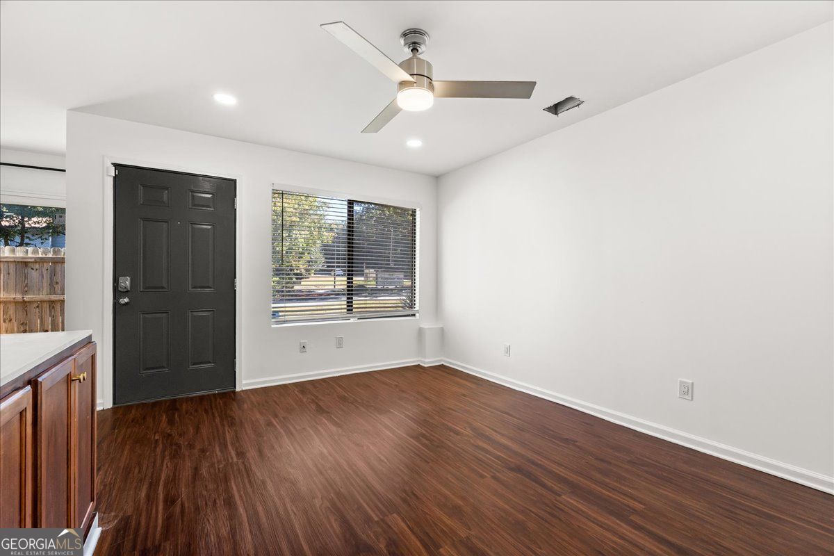 3755 Mulkey Road Marietta, GA 30008 - Photo 3 of 17 wooden floor in an empty room with a window