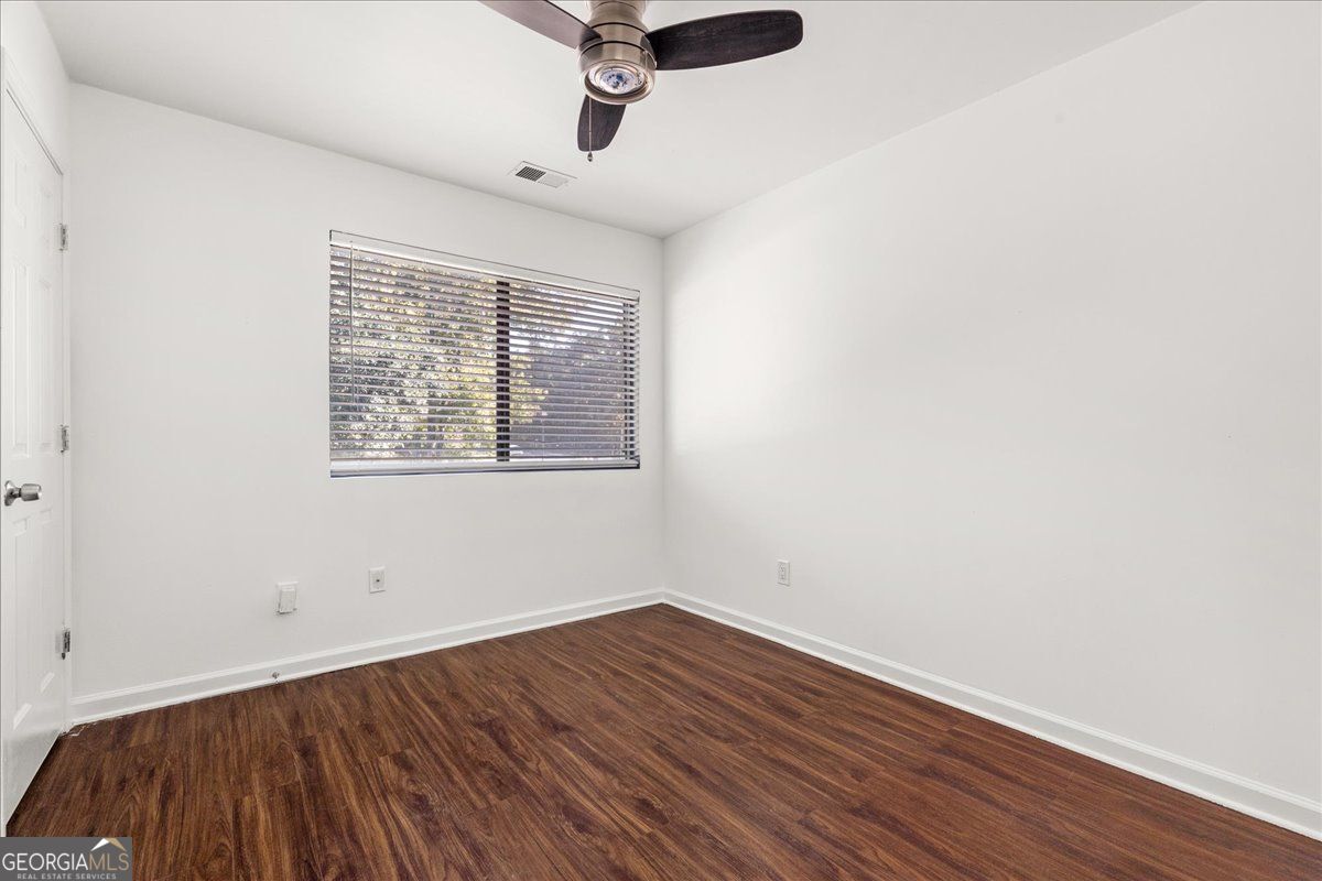 3755 Mulkey Road Marietta, GA 30008 - Photo 5 of 17 an empty room with a window and wooden floor