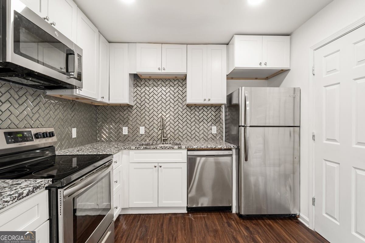 3755 Mulkey Road Marietta, GA 30008 - Photo 7 of 17 a kitchen with cabinets appliances and a counter space