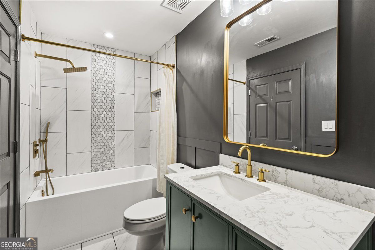 3755 Mulkey Road Marietta, GA 30008 - Photo 9 of 17 a bathroom with a granite countertop sink toilet and shower