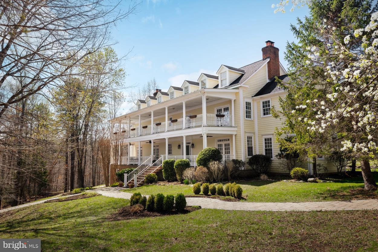 a front view of a house with a yard table and chairs