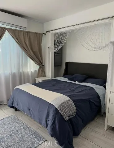 a bedroom with a bed and a window