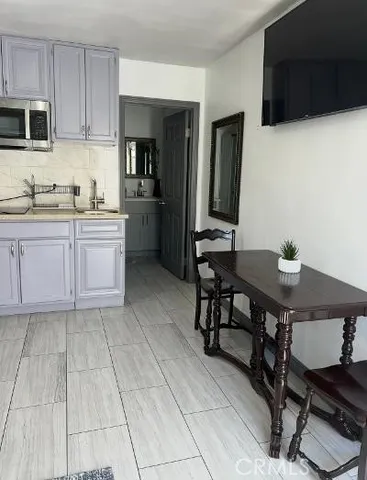 a kitchen with stainless steel appliances a stove a sink a microwave and a refrigerator